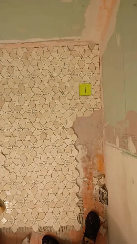 Marble floral-mosaic tile laid out across the bathroom floor