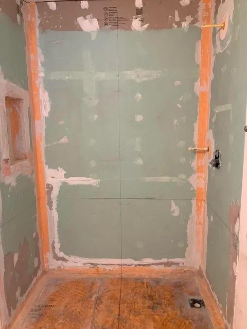 Shower walls waterproofed with Schluter Kerdi membrane before tile