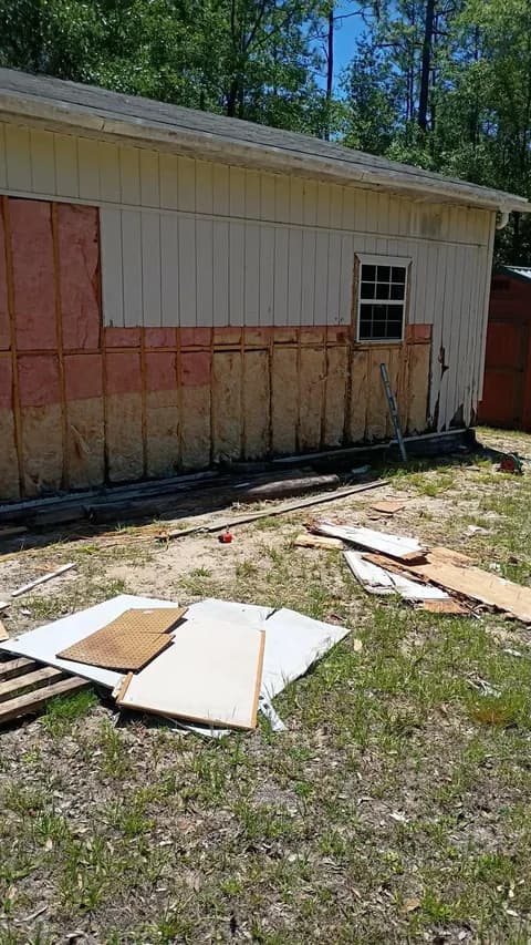 Garage side wall stripped to the studs and insulation during siding replacement