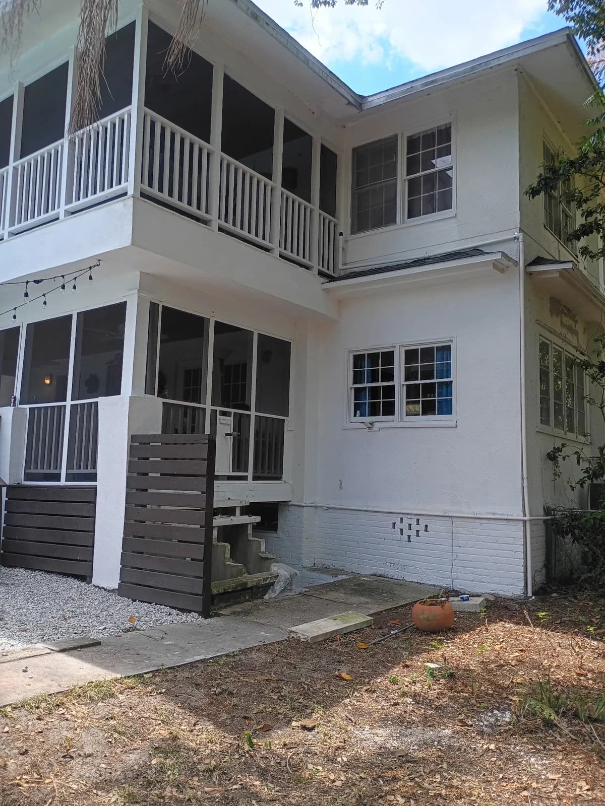 Two-story home rear after — clean screened porch and painted exterior