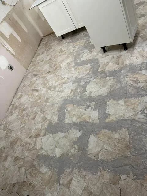 Grout going into the joints of a new stone-look tile floor