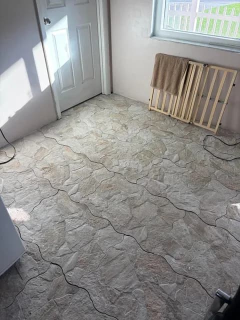Stone-look tile floor laid edge to edge in a bright room
