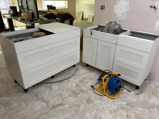 New white shaker base cabinets lined up for a kitchen island