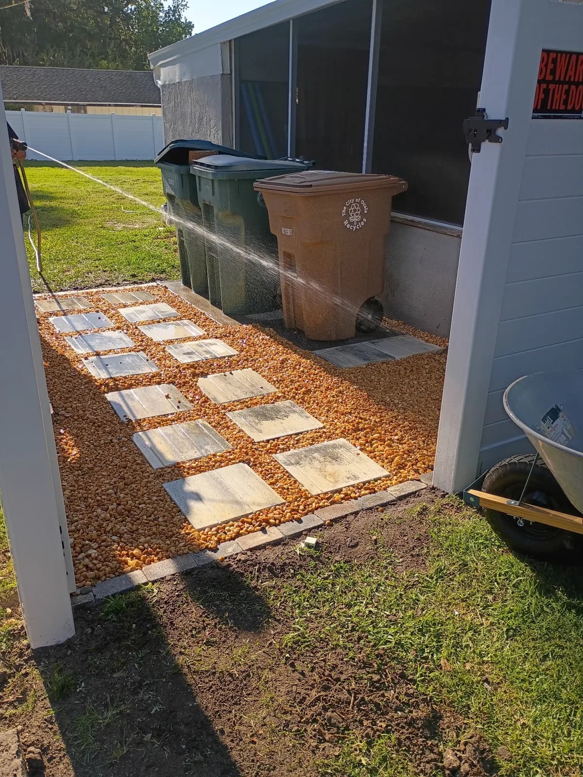 Side yard after — stepping stone pavers set in fresh pea gravel