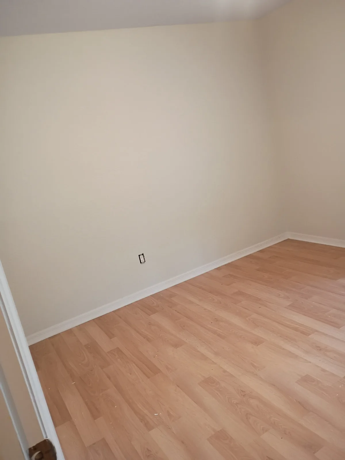 Bedroom after painting — clean cream walls and white trim