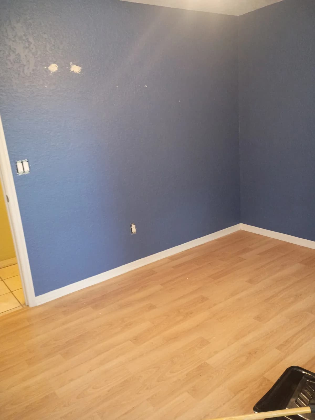 Bedroom before painting — bold blue-gray walls