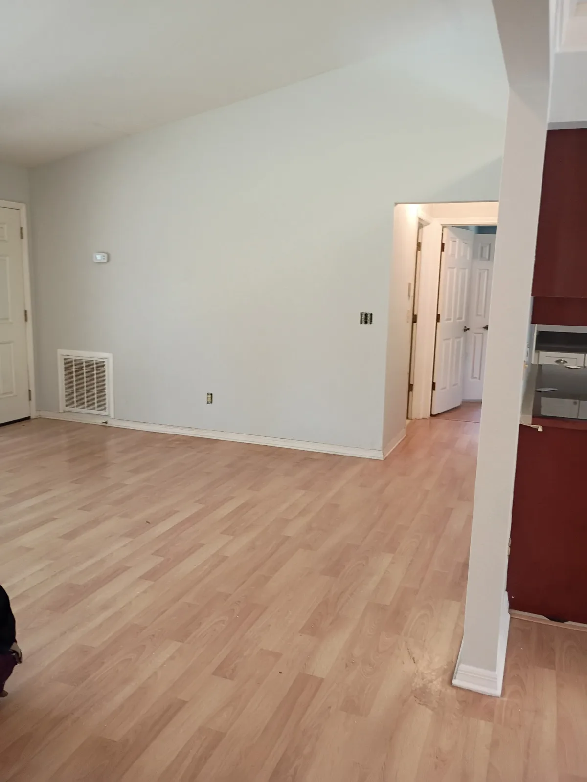 Living room after painting — white walls with vaulted ceiling