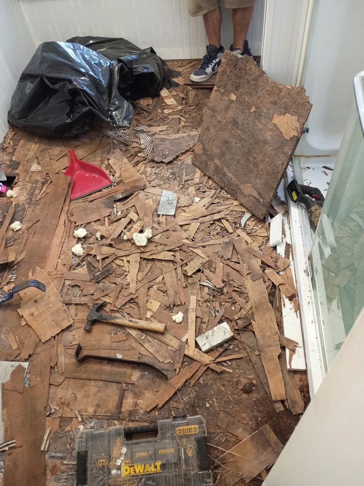Bathroom floor demolition — old flooring removed