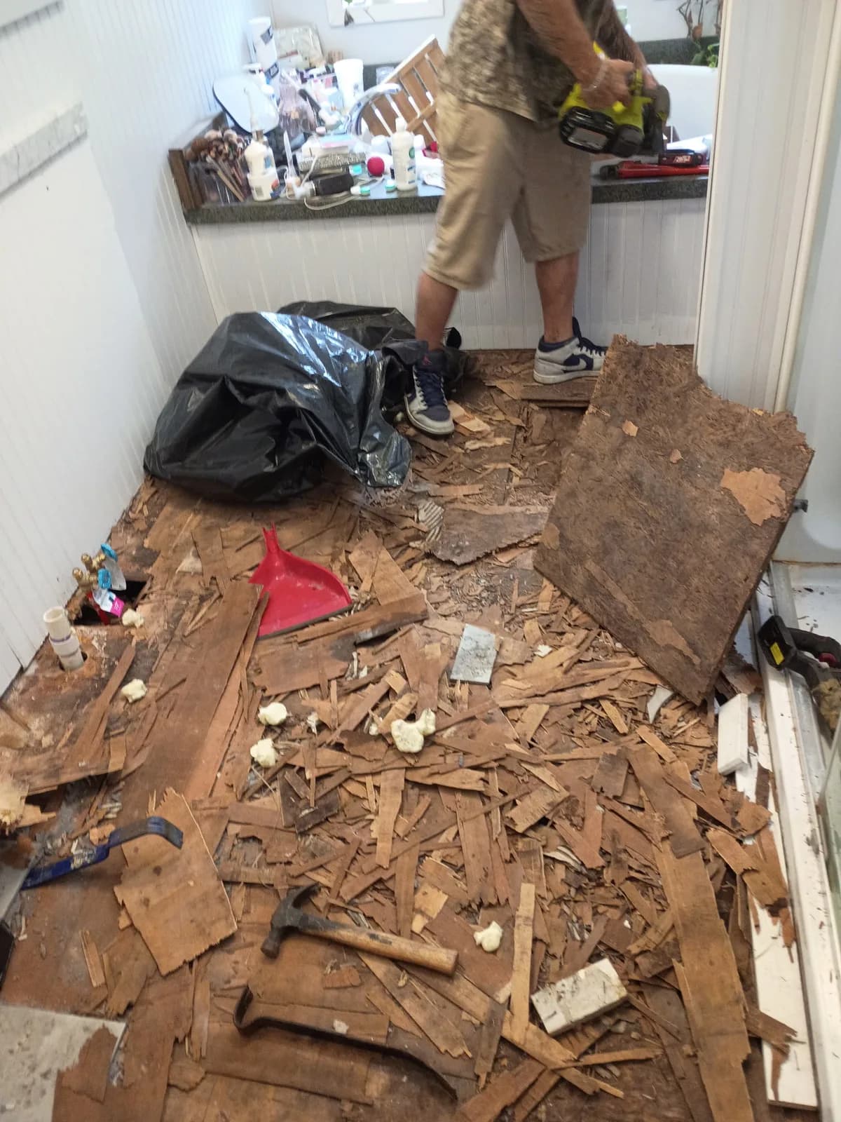 Jeff grinding up old bathroom floor during demo