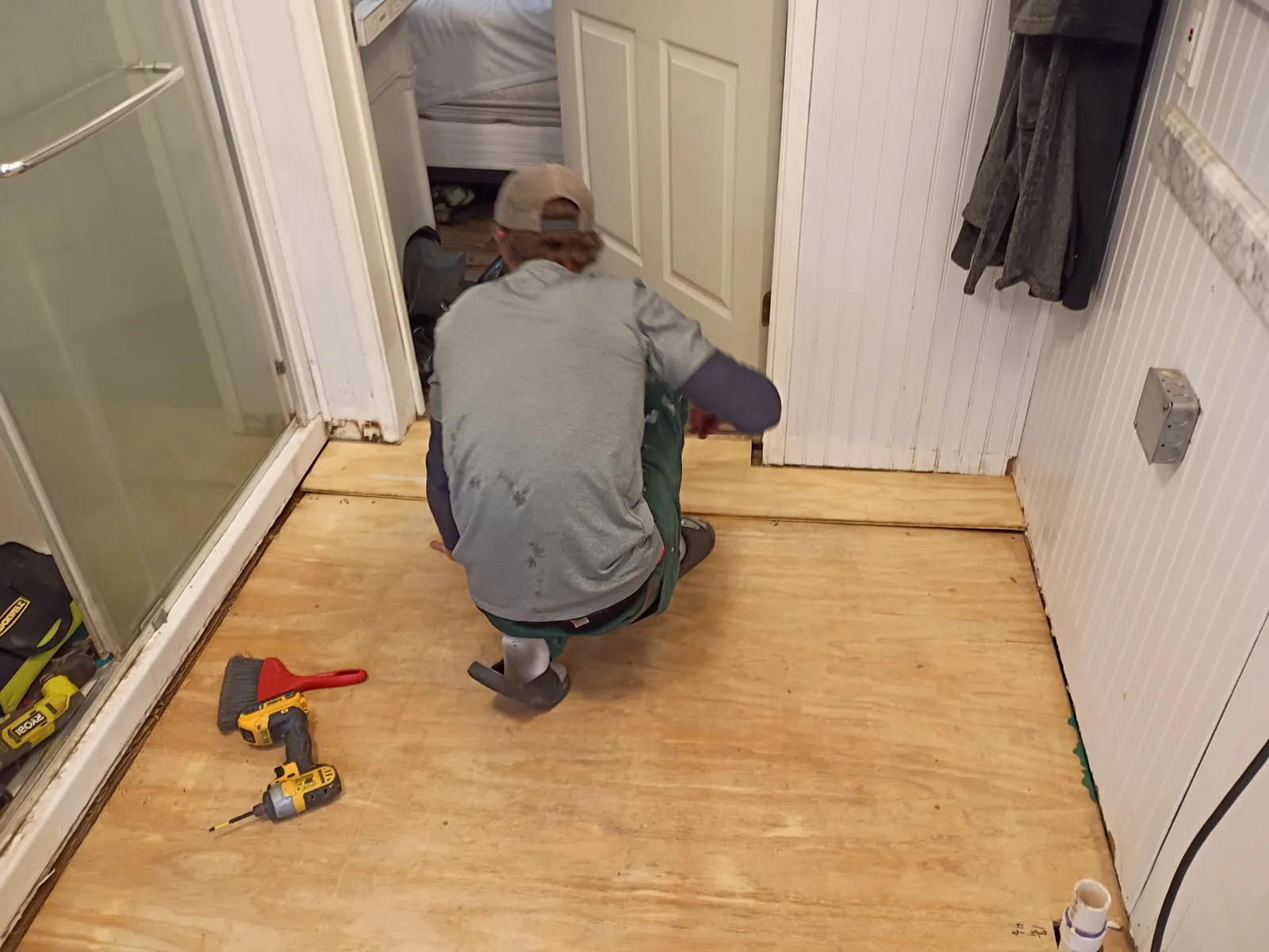 Bathroom subfloor install — wider view with shower area