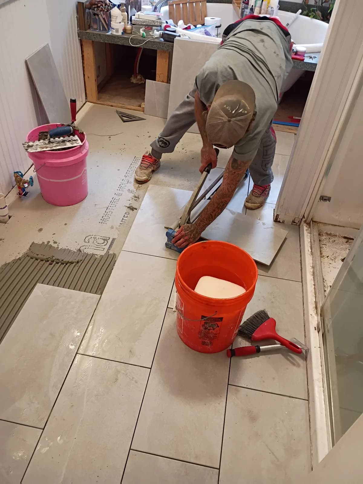 Bathroom floor tile installation — cutting large-format tile